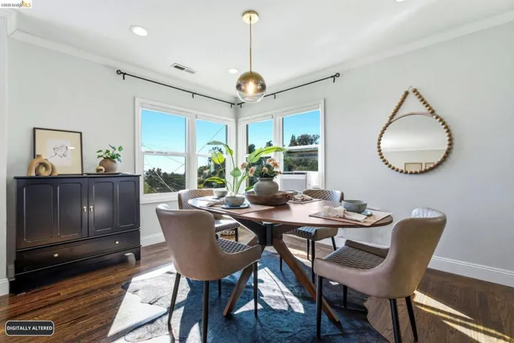 Dining area with dark wood-finish flooring, white walls, and bright white trim