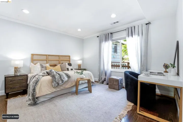 Bedsroom featuring light-toned walls with crown molding, recessed lighting, and a window with sheer and blackout drapes. On suite bath attached