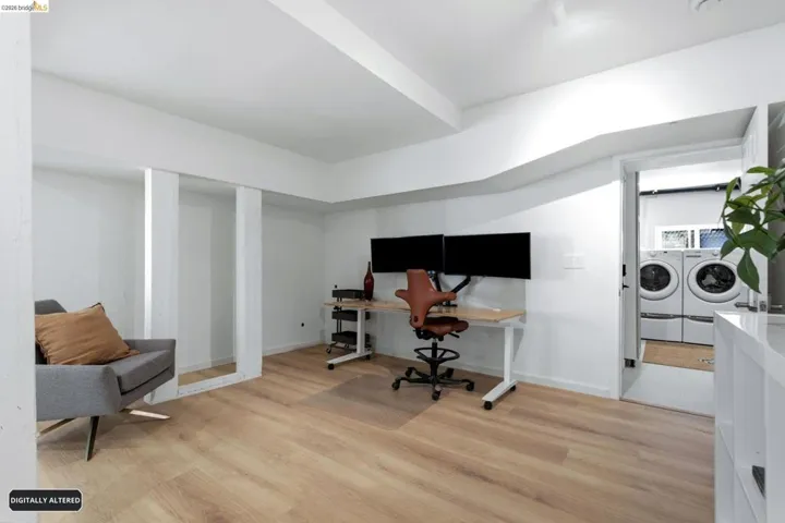 Open-concept room featuring light wood-finish flooring and white walls