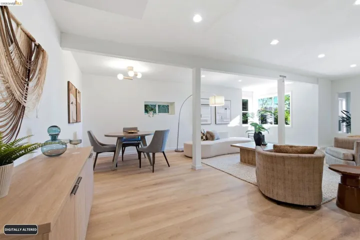 Open concept living area featuring light wood-finish flooring, white walls, and recessed lighting