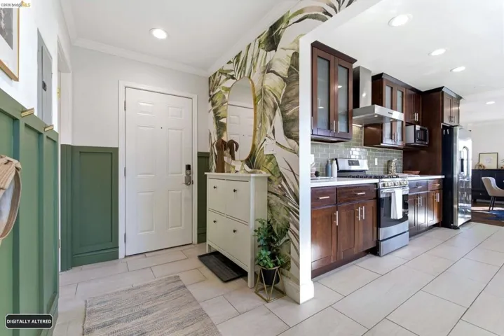 Contemporary kitchen featuring dark wood cabinetry, stainless steel appliances, and a tiled backsplash