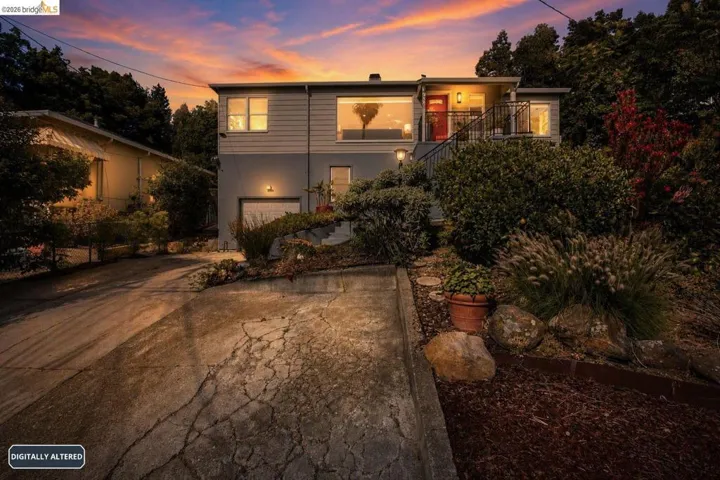 Split-level residence featuring a prominent red entry door and an integrated garage