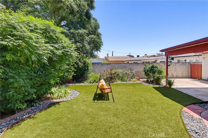 Easy care lawn with realistic artificial grass within rear yard.