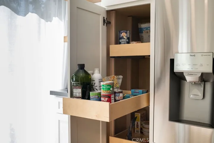 Custom pull-out shelves in pantry makes for easy access to shelf-stable food.