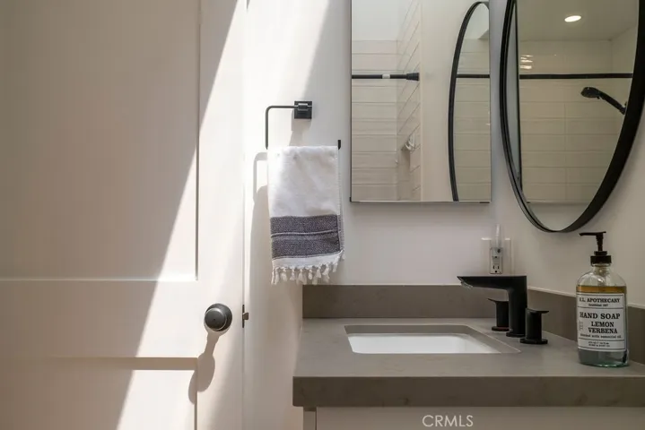 View of upstairs bathroom showing sunlight from vaulted skylight.