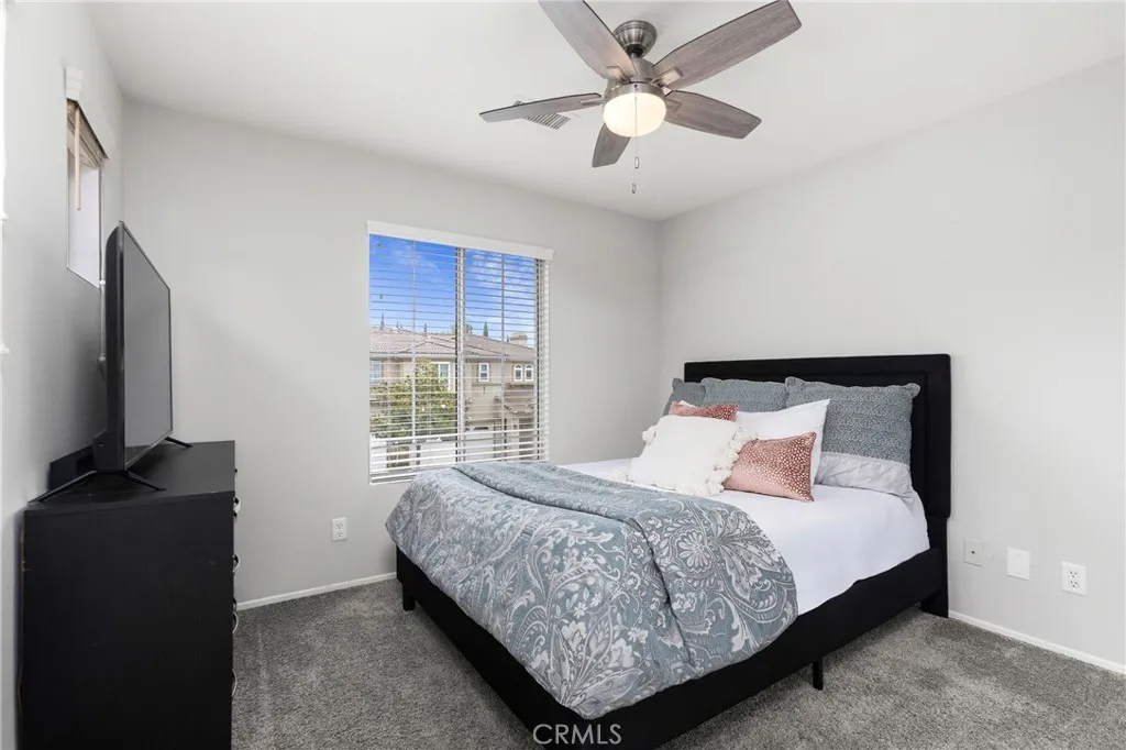 Secondary bedroom shown with queen bed