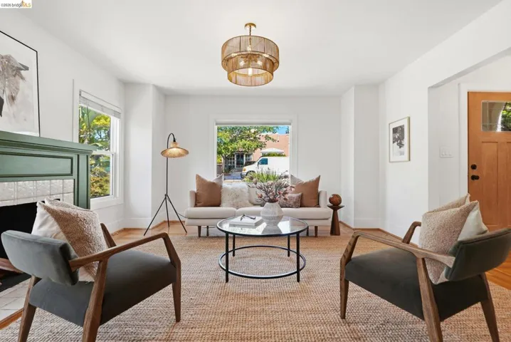 Living area featuring hardwood-finish flooring and a decorative overhead light fixture
