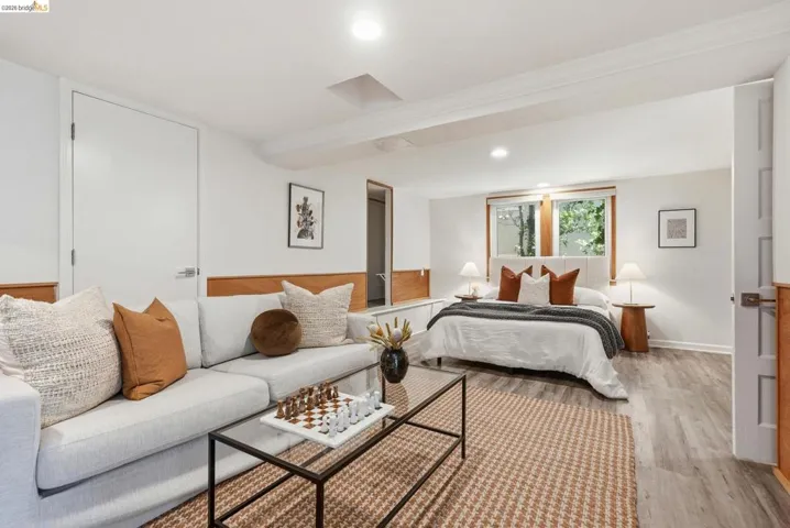 Versatile space featuring wood-finish flooring, recessed lighting, and a window with wood trim