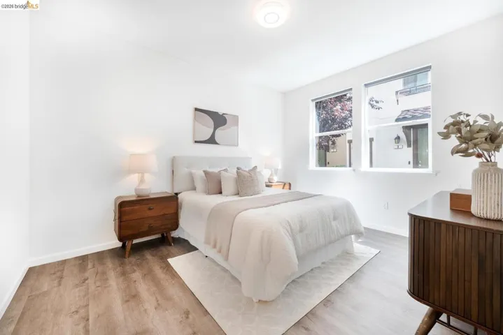 Bedroom featuring wood-finish flooring, recessed lighting, and white baseboards