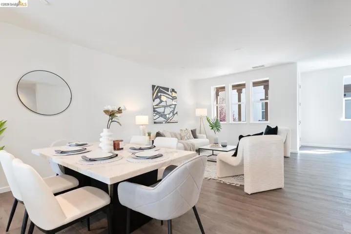 Open-concept living area with wood-finish flooring