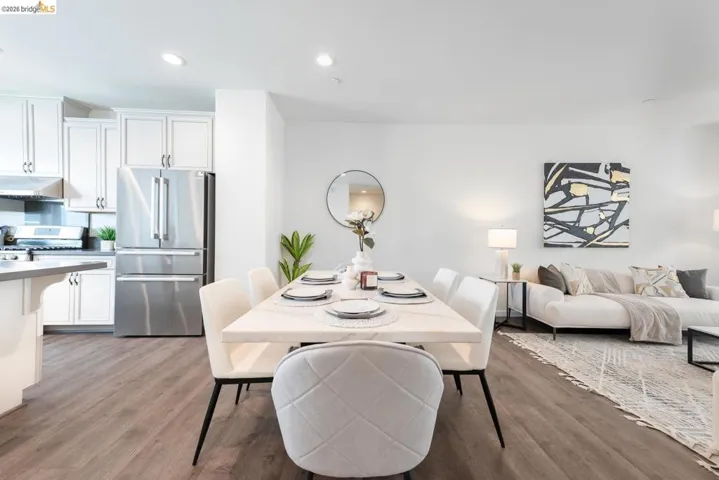 Open-concept dining area featuring wood-finish flooring