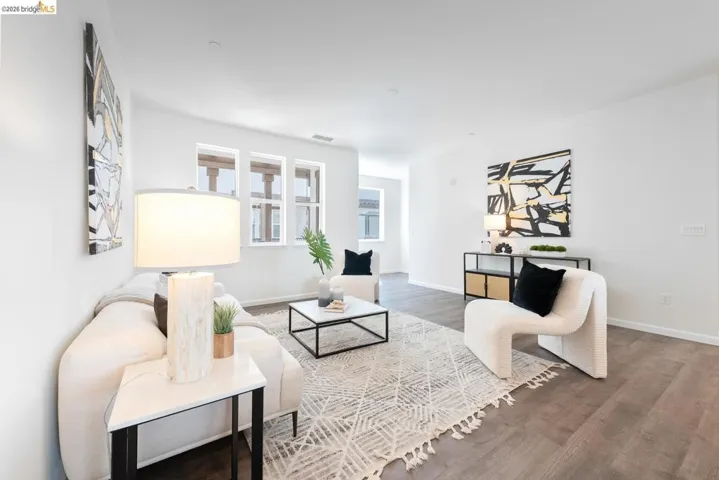 Bright living area with wood-finish flooring and recessed lighting