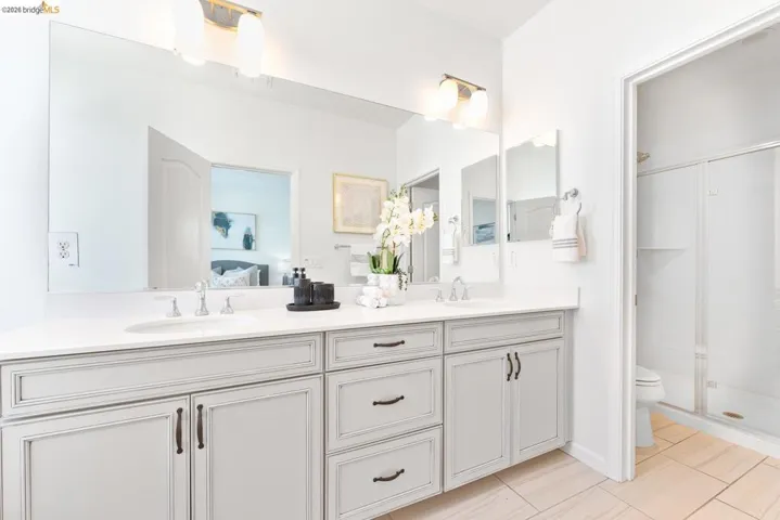 Dual vanity with undermount sinks and light gray cabinetry