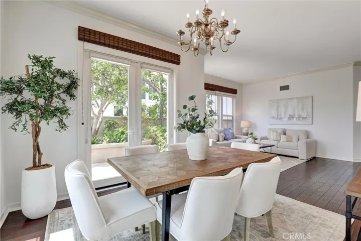 The dining area flows gracefully into the elegant living room, creating an inviting space for entertaining.