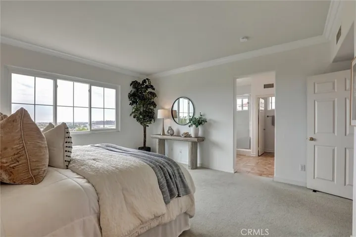 The primary suite offers generous proportions, a walk-in closet, and a well-appointed ensuite bathroom.