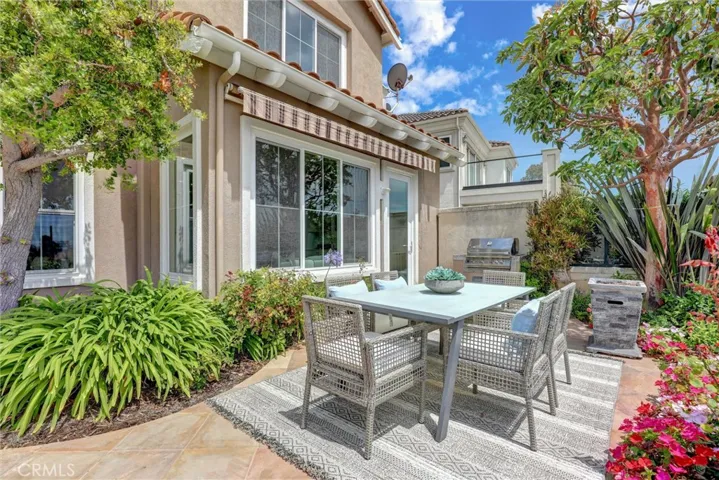 The private patio is designed for effortless outdoor dining, complete with a built-in barbecue and beautifully landscaped surroundings.