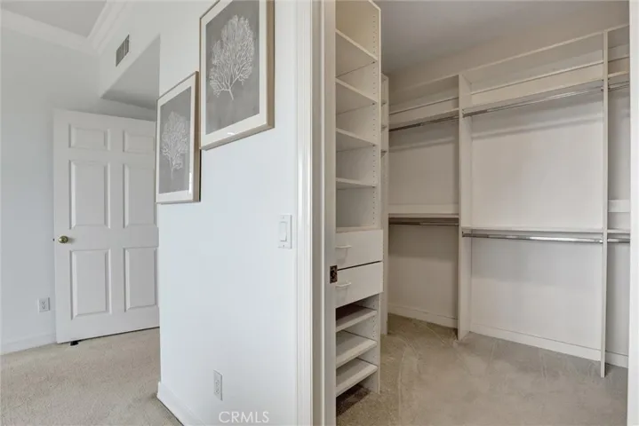 The expansive walk-in closet combines exceptional storage with custom built-in organization.