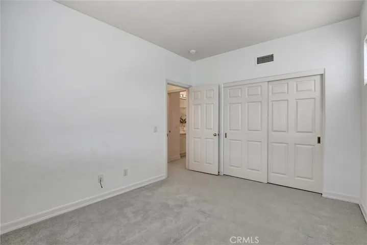 This inviting secondary bedroom is filled with natural light and offers comfortable accommodations for family or guests.