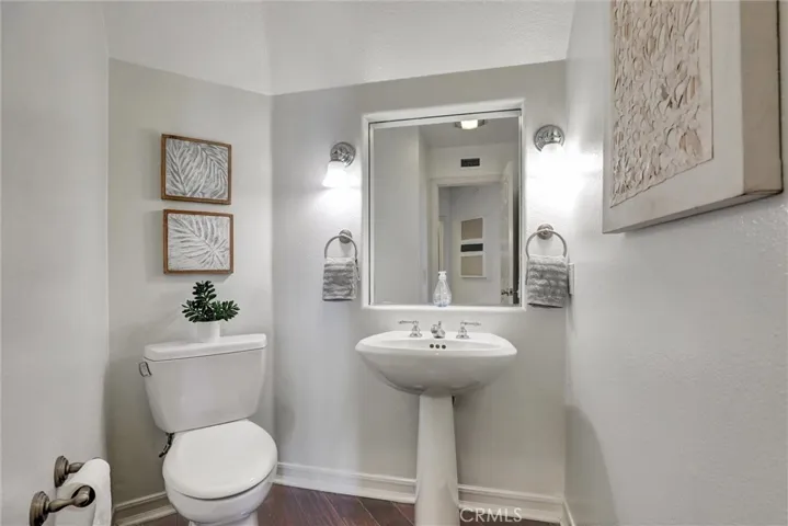 A conveniently located guest powder room serves the main living areas.