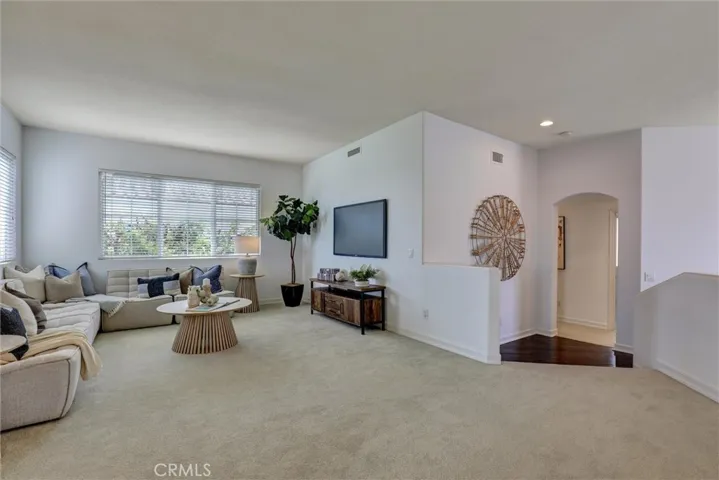 The spacious upstairs loft provides a versatile living area ideal for a family room, home office, or media space.