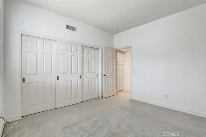 A well-proportioned secondary bedroom offers flexibility for family, guests, or a home office.