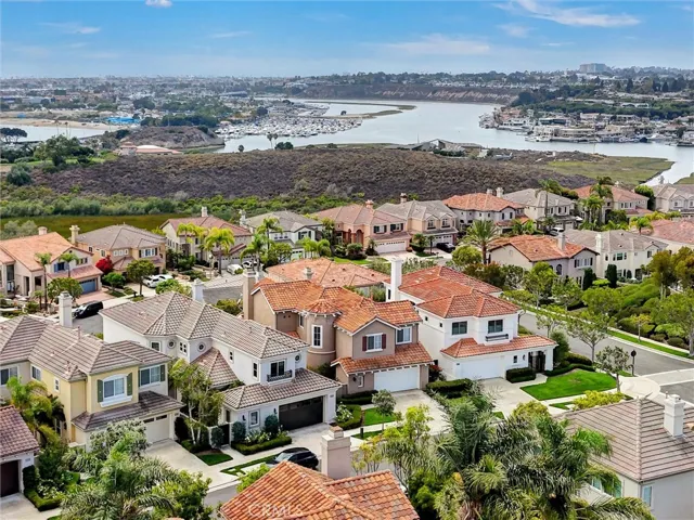 An expansive aerial perspective showcases the home's exceptional Newport Beach location, overlooking the Newport Back Bay with sweeping bay, coastal, and city light views just moments from world-class beaches, dining, and shopping.