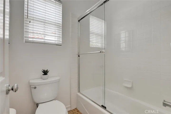 The secondary bathroom offers the convenience of both a shower and bathtub, providing flexibility for family members and guests.