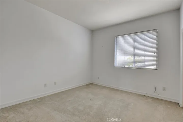 A comfortable secondary bedroom with abundant natural light and generous closet space.