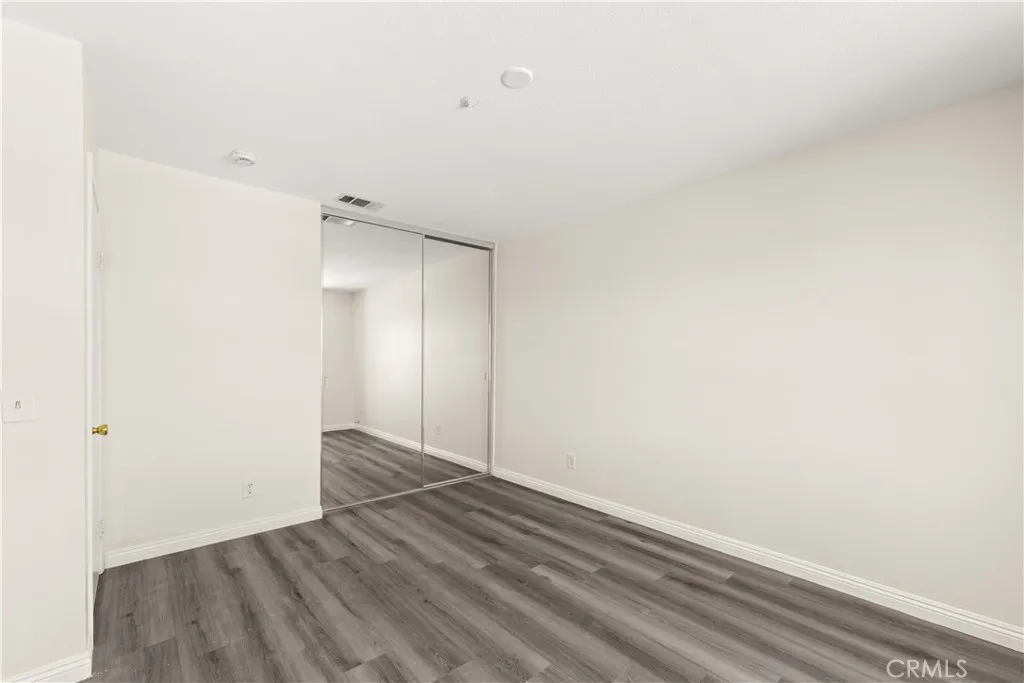 Guest Bedroom with mirrored closet doors.