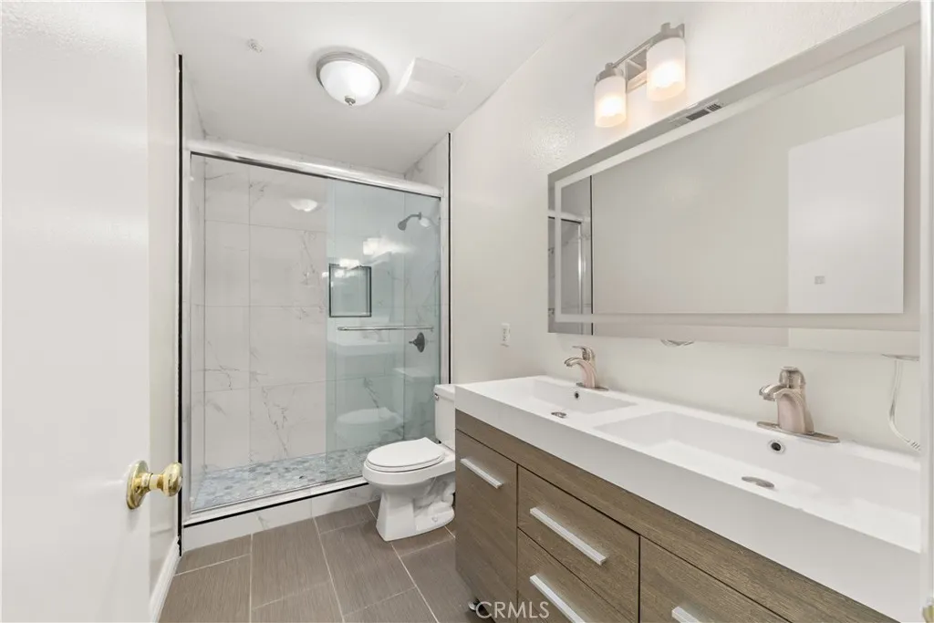 Beautiful new guest bath with a step-in shower, dual sinks and a perfect makeup mirror.
