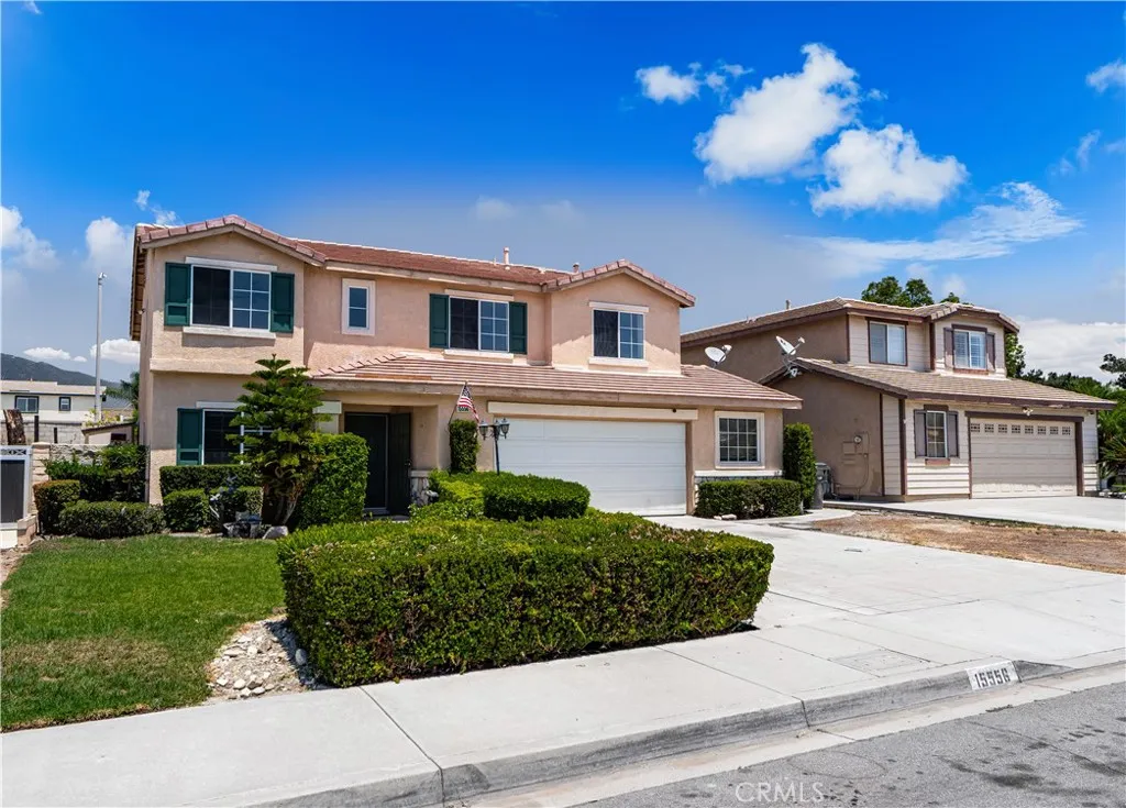 Front view of the home with a large driveway.