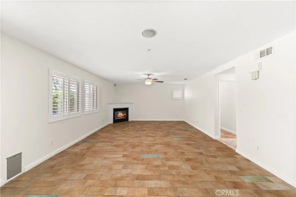 Family room with tile flooring and large windows for bright natural light.