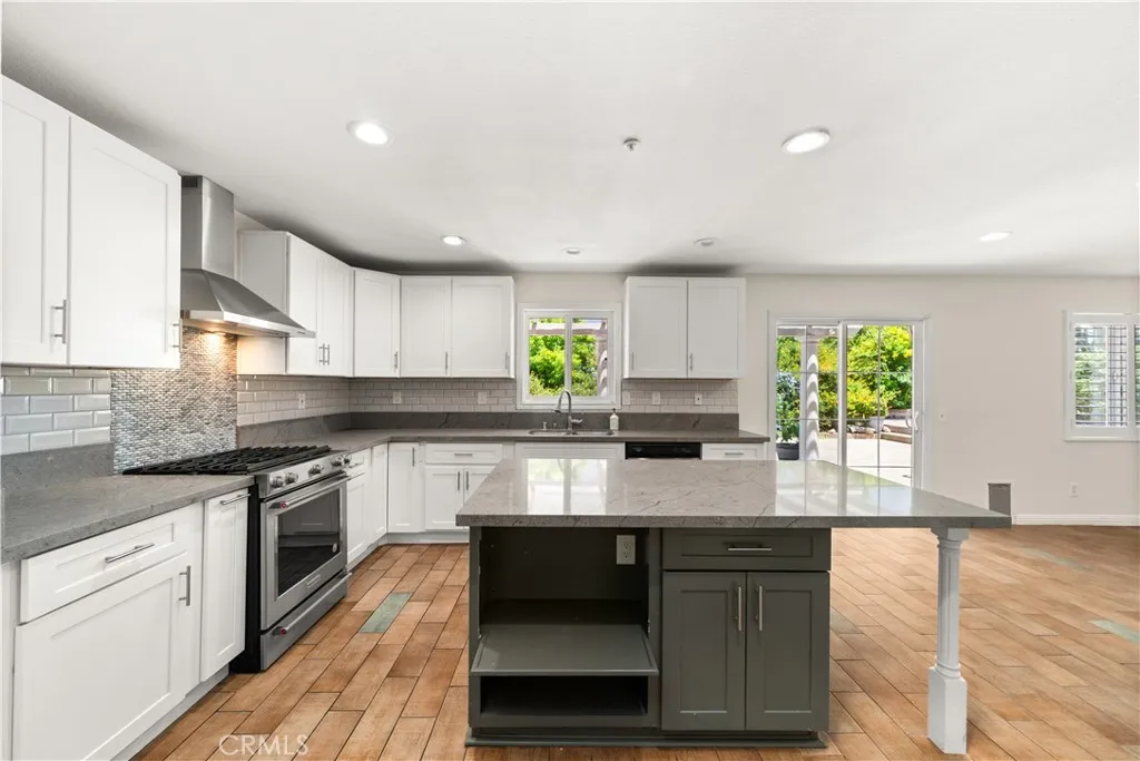 Remodeled kitchen with sliding glass door leading to the back patio and yard.