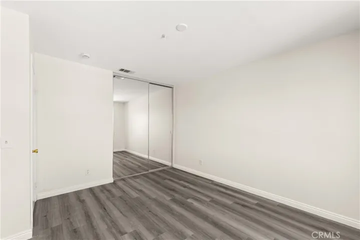 Guest Bedroom with mirrored closet doors.