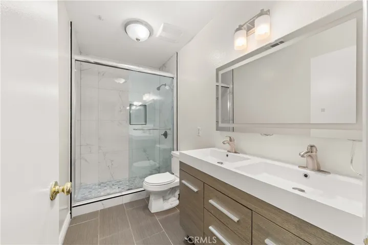 Beautiful new guest bath with a step-in shower, dual sinks and a perfect makeup mirror.