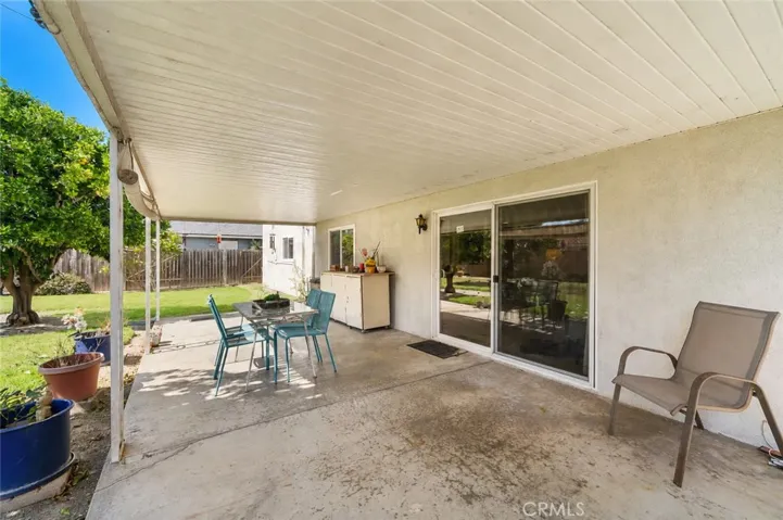 Covered Patio Surrounding by Expansive Lawn and Fruit Trees