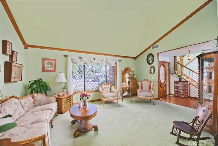 Living room with high ceilings and lead beveled glass windows