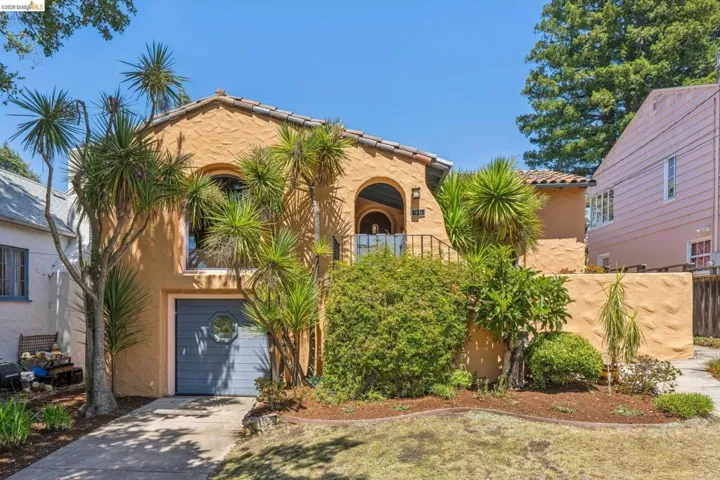Mediterranean-style stucco exterior with arched windows and a terracotta tile roof