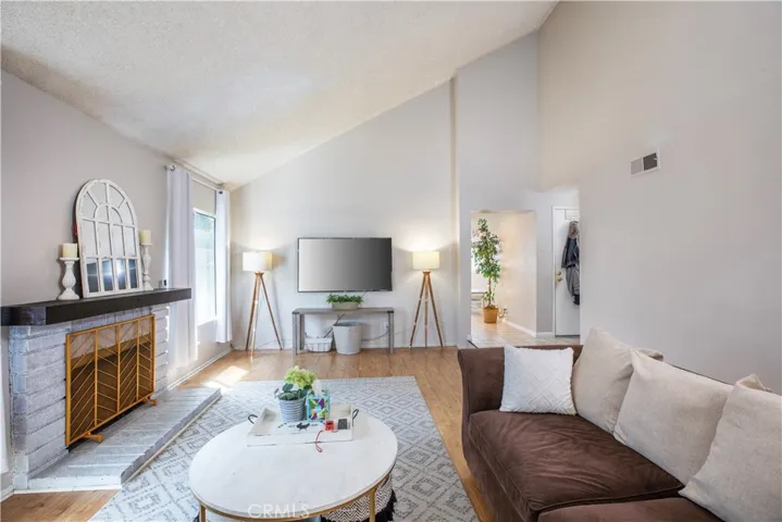 Bonus room with vaulted ceiling and fireplace