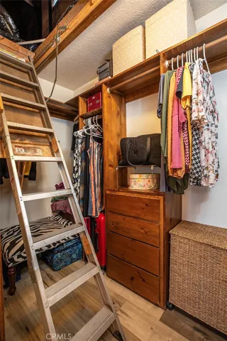 Walk in closet with attic pull-down stairs.