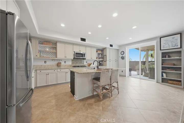Open Kitchen with center island that opens to the family room and covered patio