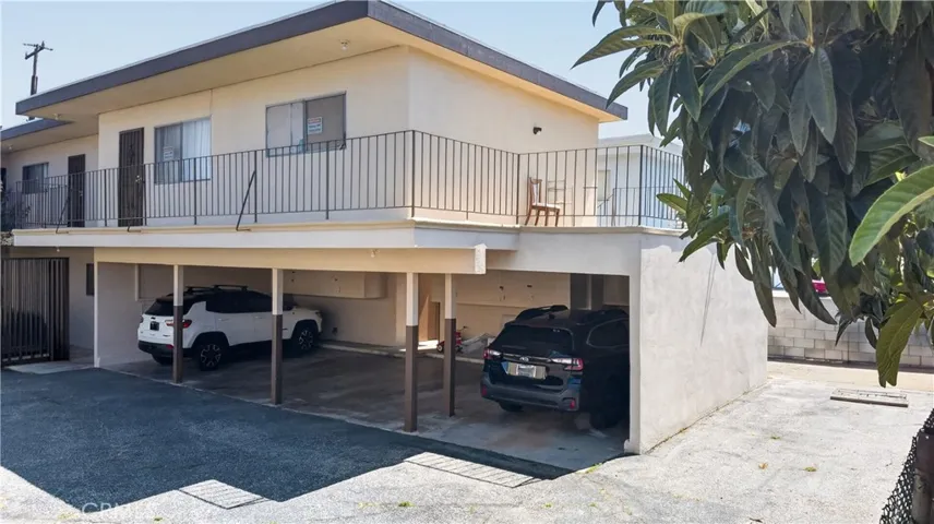 Back exterior. Carport with 4 parking spaces