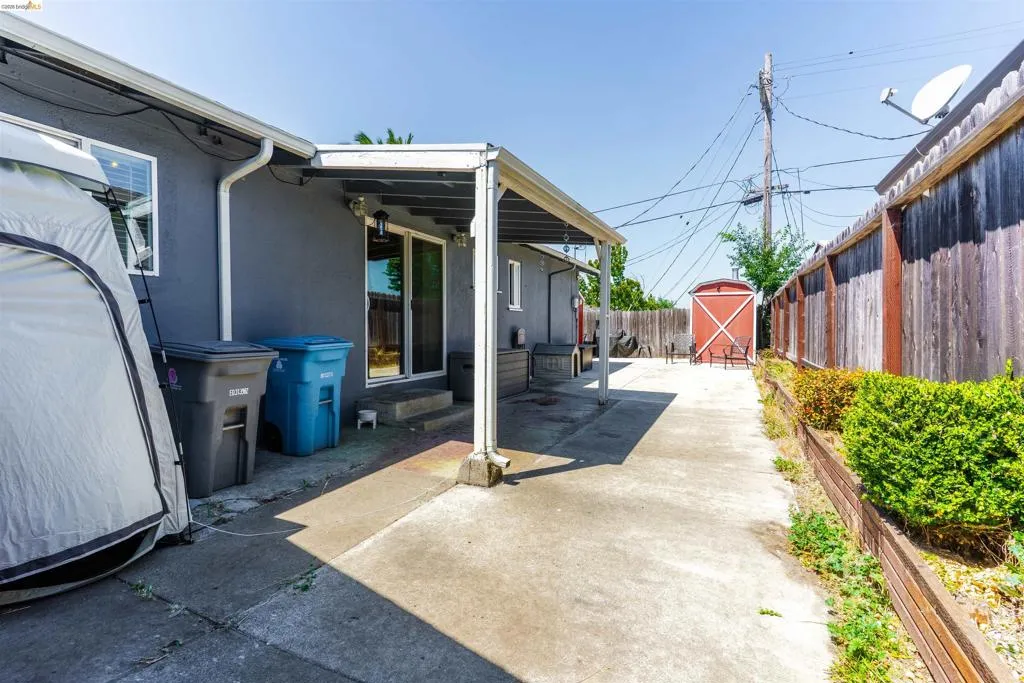 Concrete patio with covered area and sliding glass door access