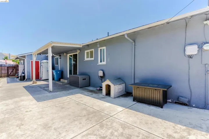 Expansive concrete patio area with a covered section, providing outdoor living space