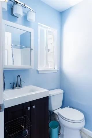 Bathroom featuring a single-sink vanity with a dark wood-finish cabinet, white basin, and brushed nickel faucet