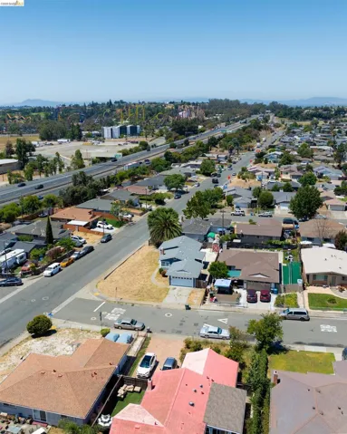 Residential streetscape with a mix of single-story homes and mature landscaping