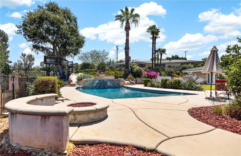 view of pool off side of gazebo.  Fire pit is gas.