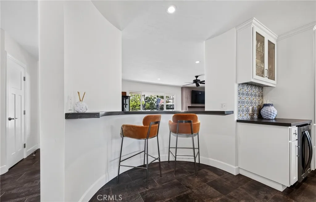 bar seating area inside kitchen looking into family room