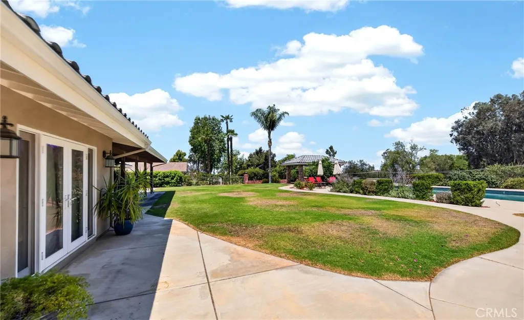 Side view of backyard.  Double doors are primary bedroom.