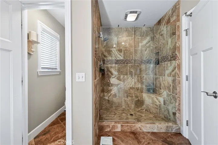 Separate shower and toliet area in primary room.